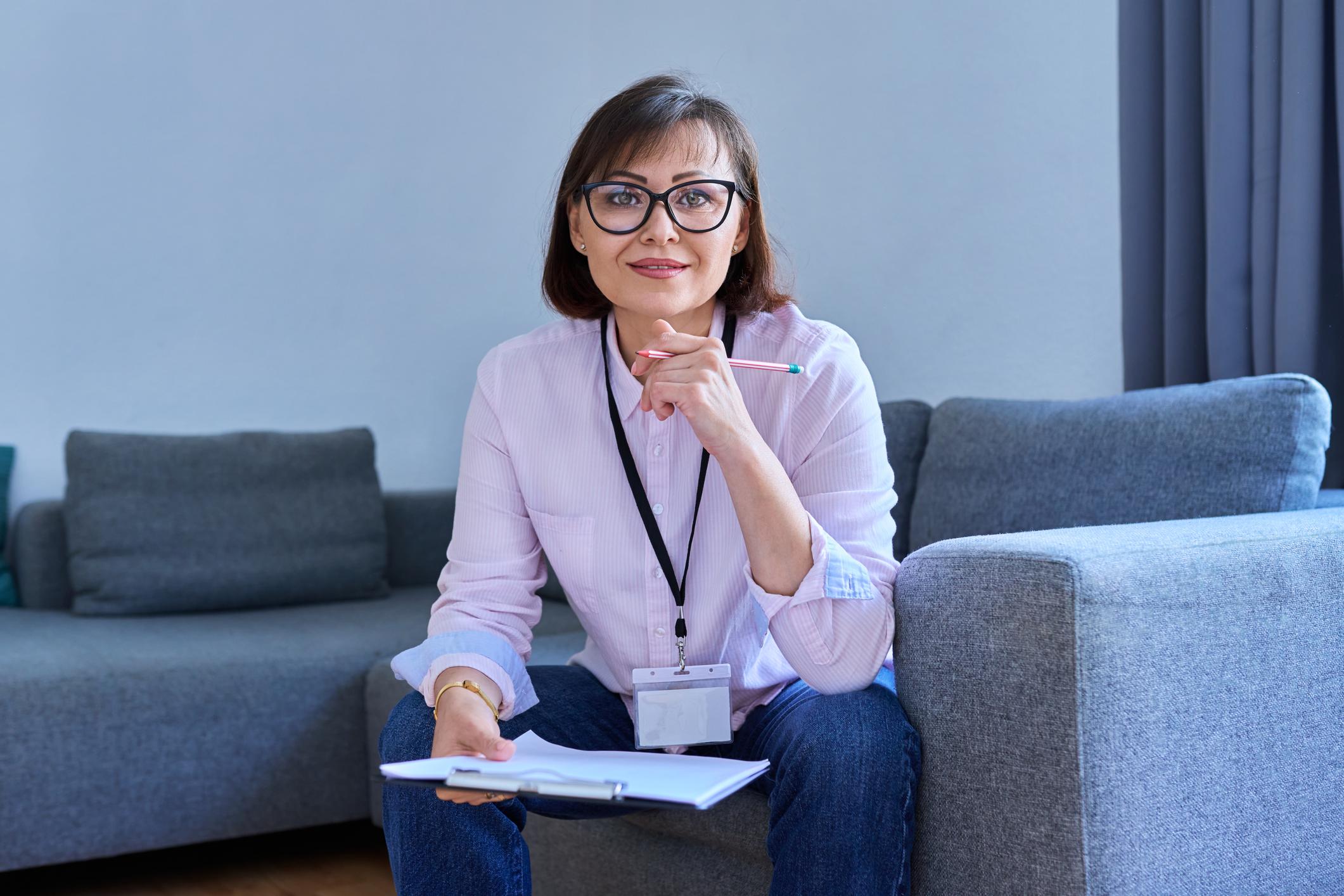 woman holding clipboard looking at camera